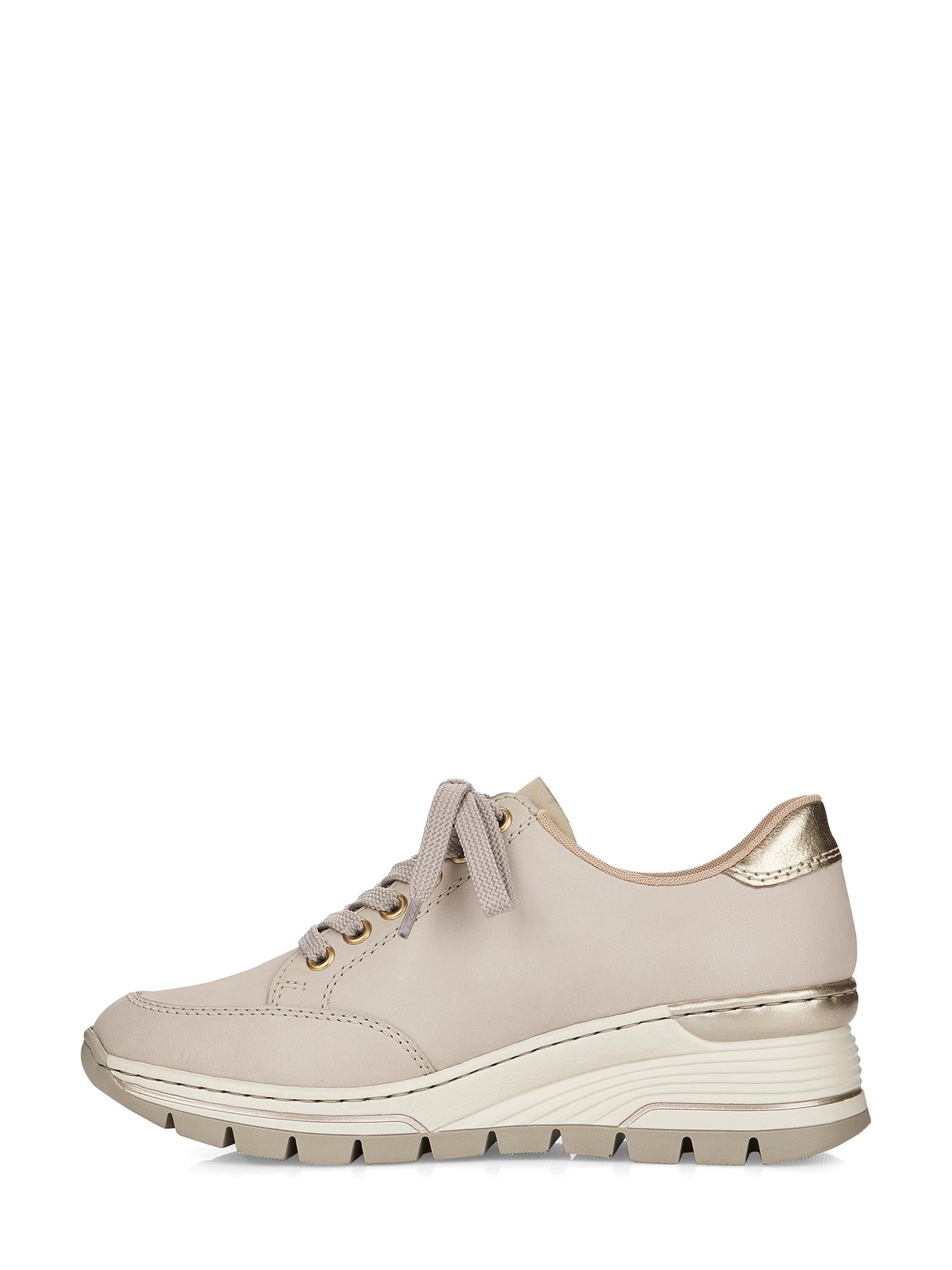 Rieker Comfort & Style 06829 Golden Beige Sneaker har en beige overdel, beige lisser, metallisk gullfargede hældetaljer og en tykk kremfarget kilesåle med svart rillet mønster. Vist i sideprofil mot en hvit bakgrunn.