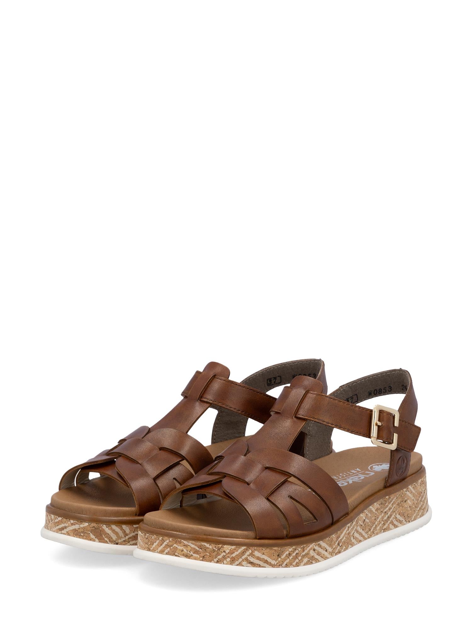 03447 Rieker Toscana Leather Sandal fra Rieker Comfort & Style har brune, vevde lærremmer, ankelspenne, brunbrun, strukturert såle med signaturkomfort, hvitt dekorativt mønster og åpne tær og hæler for stil og komfort.