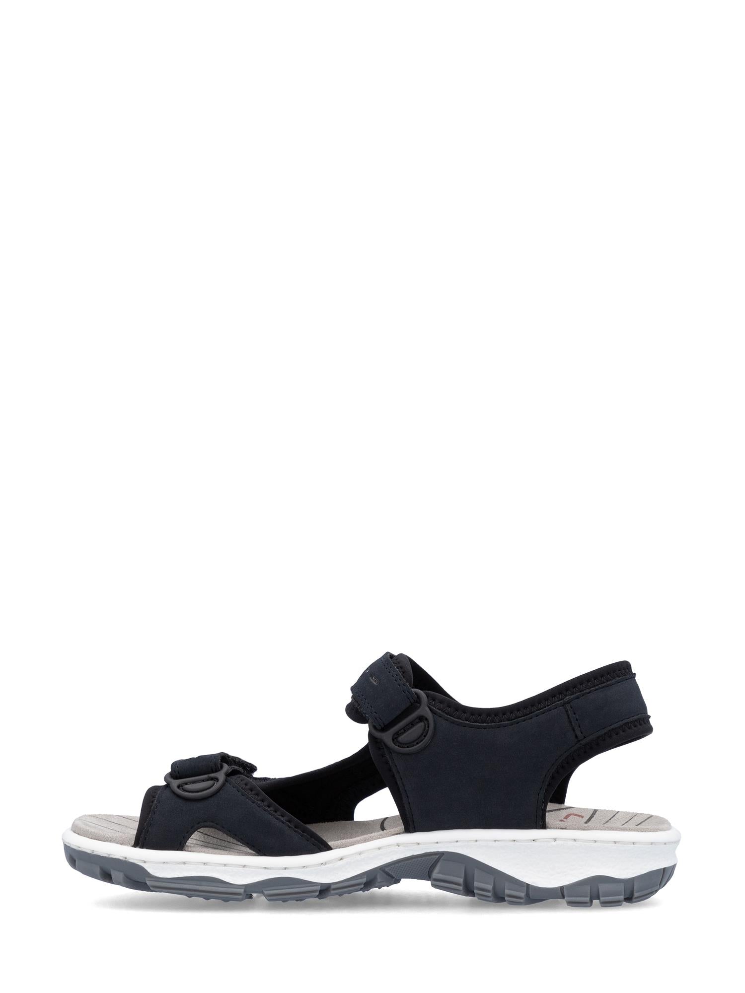 03009 Rieker Marine ComfortWave Sandal fra Rieker Comfort & Style er en svart damesandal med åpen tå, borrelåsstropper og hvit strukturert såle, designet for komfort hele dagen og utendørs bruk. Vist fra siden på hvit, med ComfortWave-teknologi.